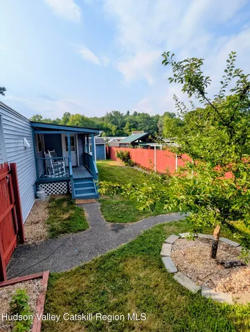a view of a white house with a yard