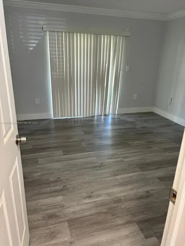 a view of wooden floor and windows in a room