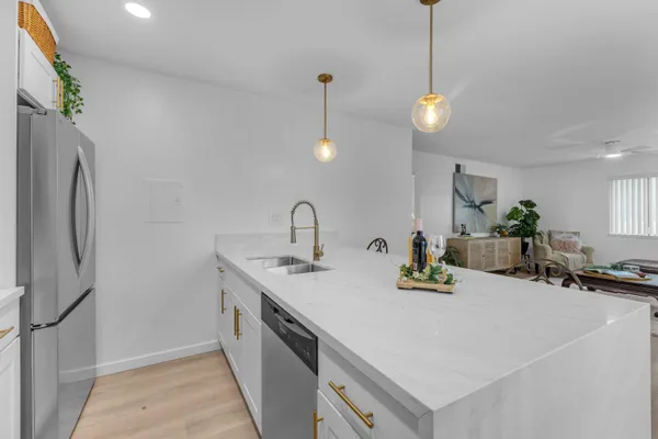 a kitchen with a sink a counter and chairs