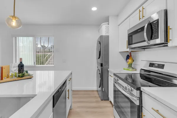 a kitchen with a sink and chandelier