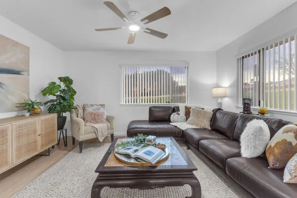 a living room with furniture a table and a potted plant
