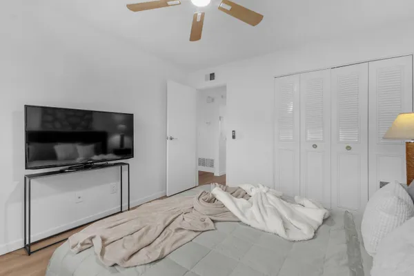 a bedroom with a bed and painting on the wall