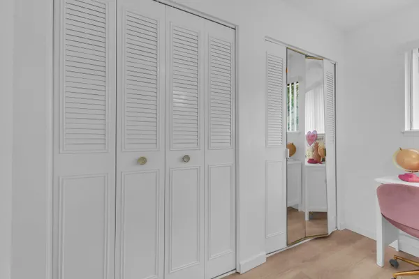 a view of hallway with furniture and wooden floor