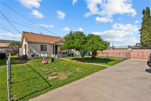 a view of a house with backyard porch and sitting area