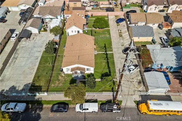an aerial view of a houses with yard