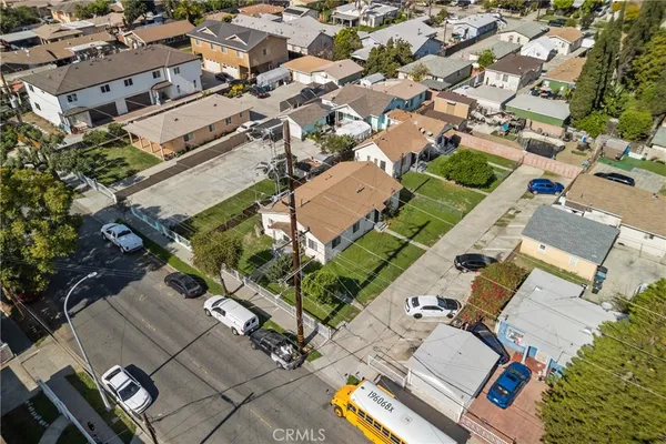 an aerial view of a house with a yard