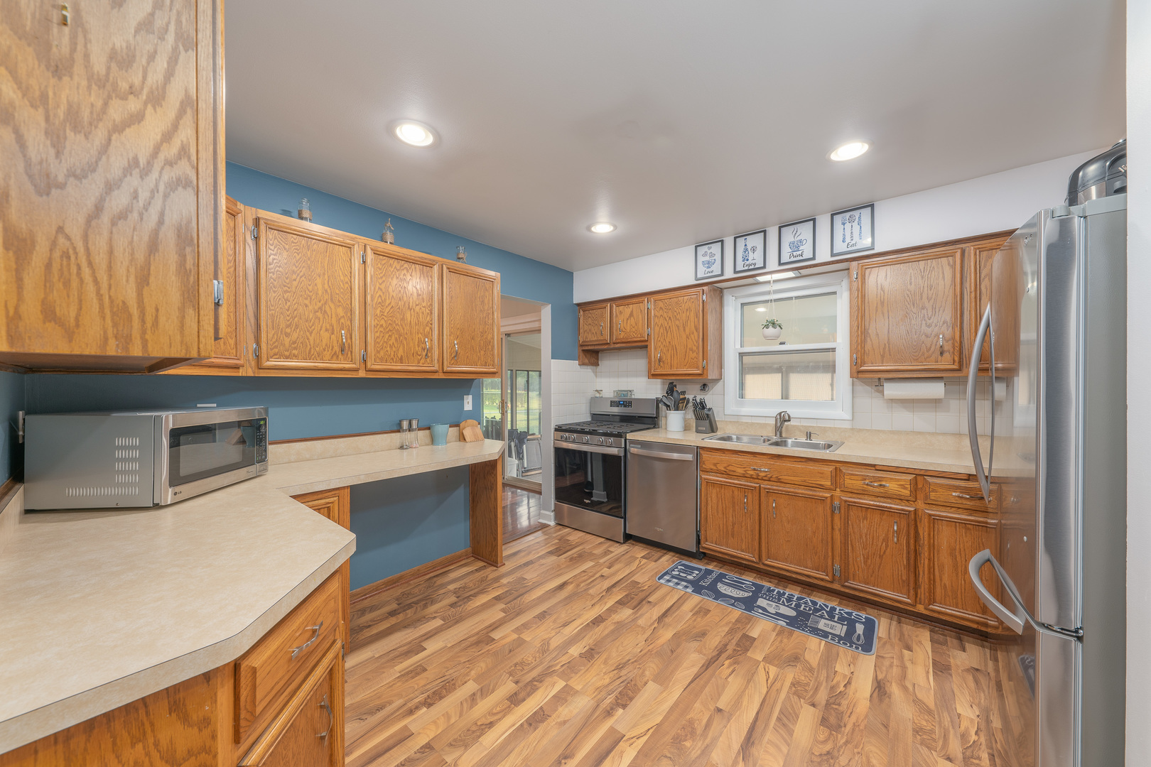 817 Southgate Road New Lenox, IL 60451 - Photo 9 of 30 a kitchen with stainless steel appliances granite countertop a refrigerator a sink dishwasher a stove and white countertops with wooden floor