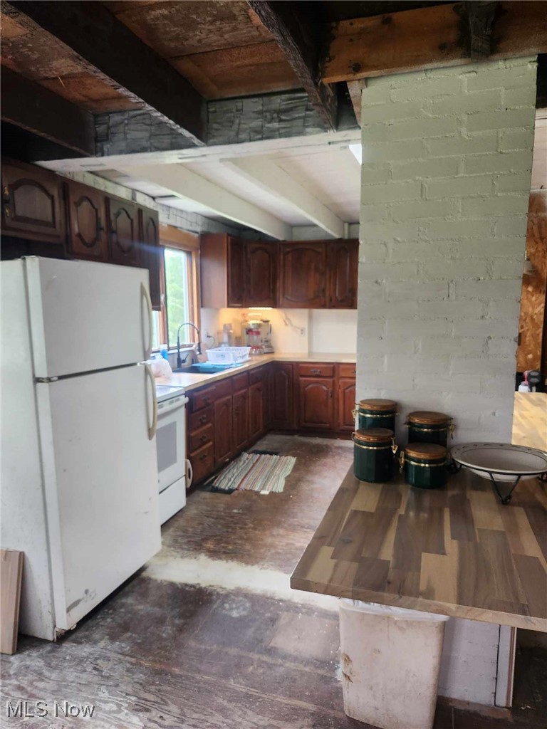 7481 Lafayette Road Lodi, OH 44254 - Photo 2 of 13 Kitchen with dark wood-type flooring, white appliances, beam ceiling, and sink