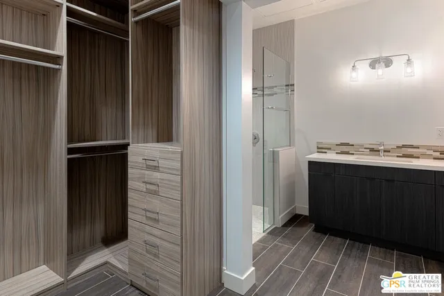 a view of a closet area with wooden floor