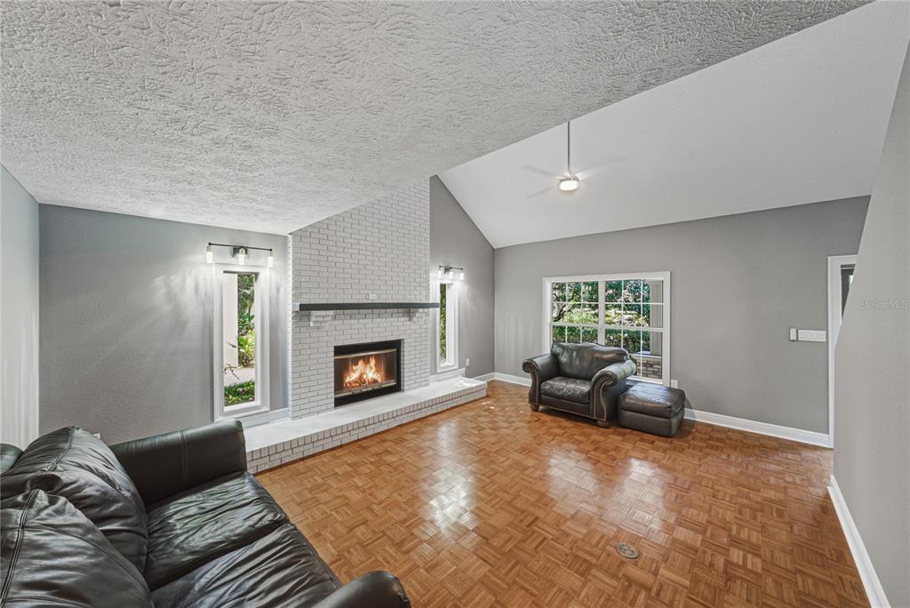 3505 Gallagher Road Dover, FL 33527 - Photo 66 of 100 a living room with furniture and a fireplace