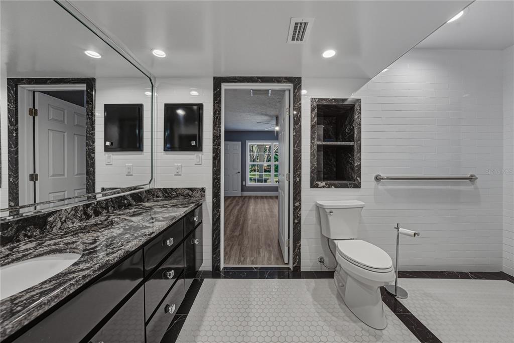 3505 Gallagher Road Dover, FL 33527 - Photo 68 of 100 a bathroom with a toilet sink and mirror