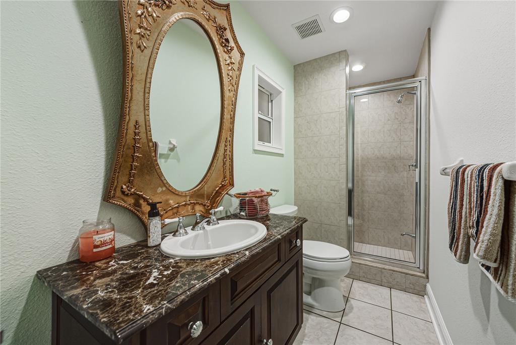 3505 Gallagher Road Dover, FL 33527 - Photo 74 of 100 a bathroom with a granite countertop sink and a mirror