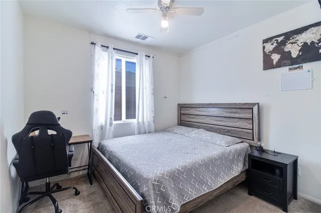 a bedroom with a bed and a chair