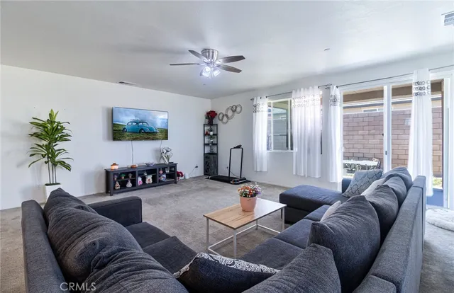 a living room with furniture and a large window