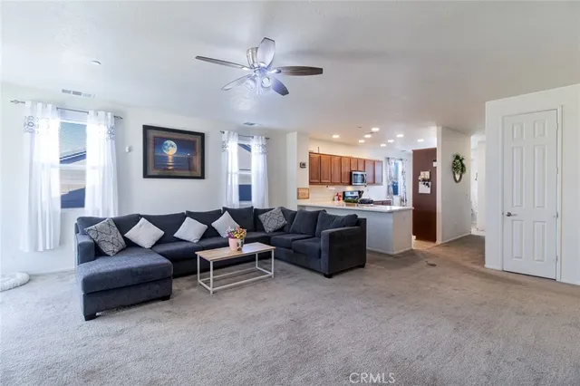 a living room with furniture and kitchen view