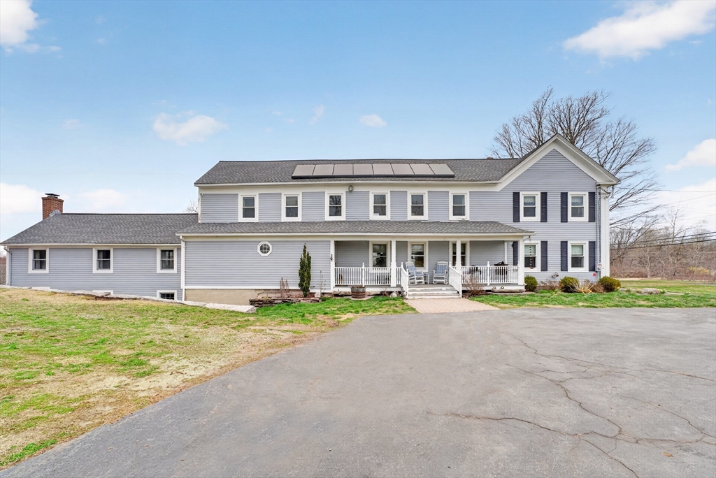 47 Singletary Avenue Sutton, MA 01590 - Photo 2 of 42 a view of house with a big yard and large trees