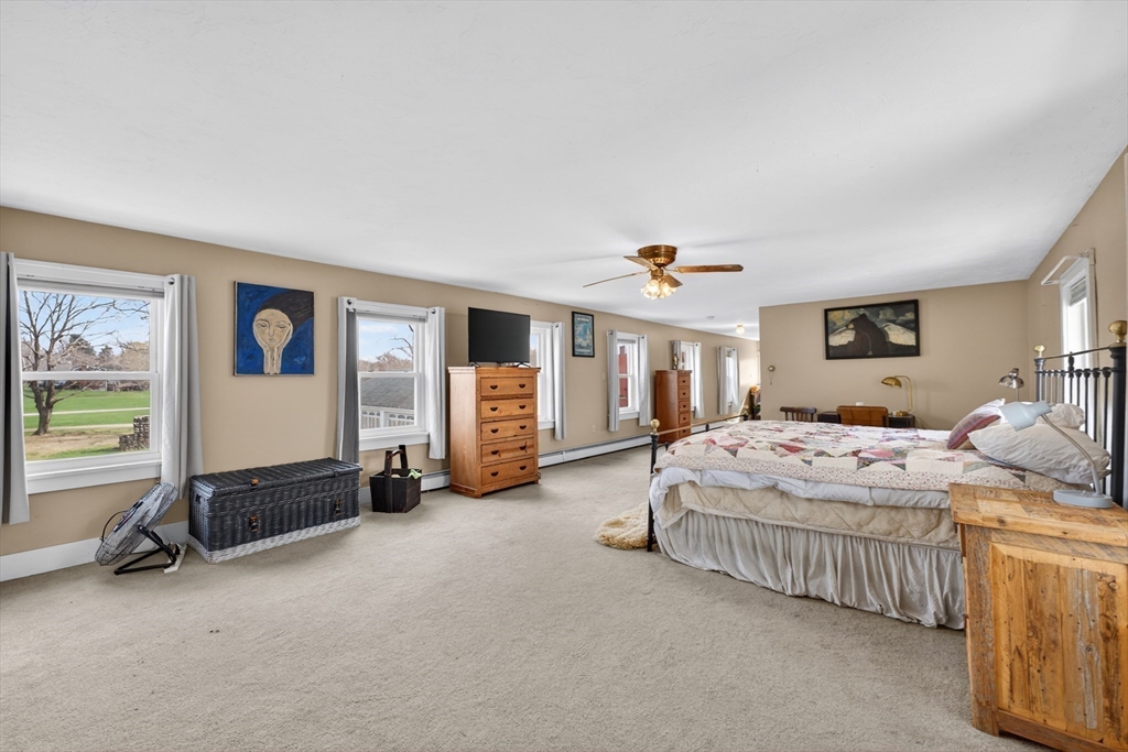 47 Singletary Avenue Sutton, MA 01590 - Photo 23 of 42 a bedroom with a bed and a chandelier