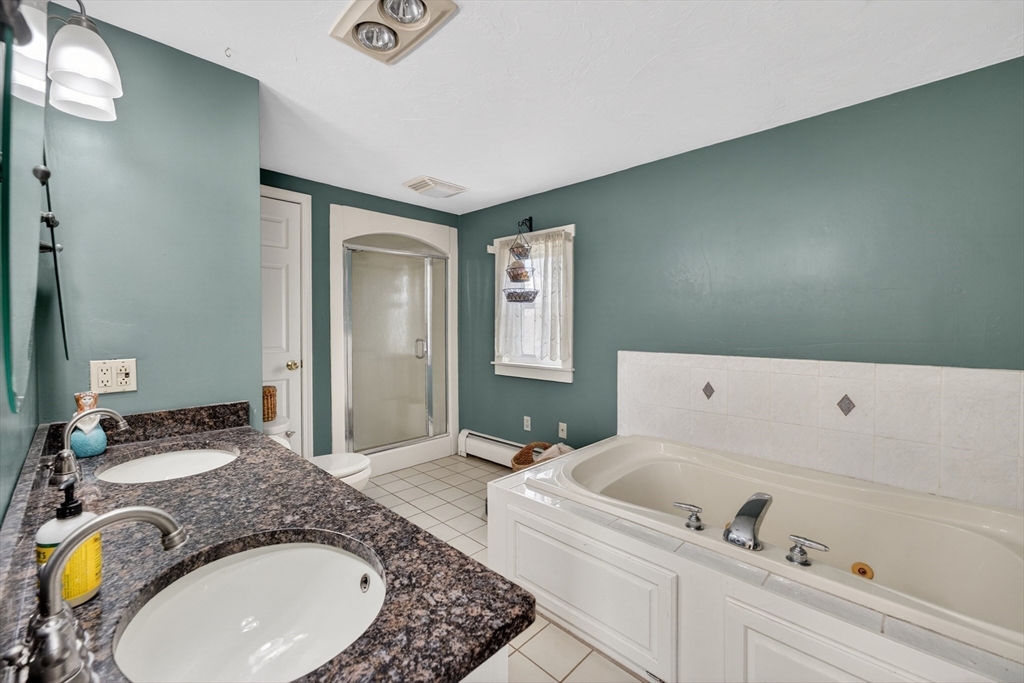 47 Singletary Avenue Sutton, MA 01590 - Photo 25 of 42 a en suite bathroom with a granite countertop tub and 2 sink