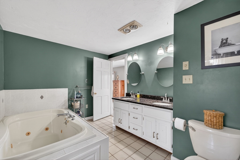 47 Singletary Avenue Sutton, MA 01590 - Photo 26 of 42 a bathroom with a bathtub sink mirror vanity and toilet