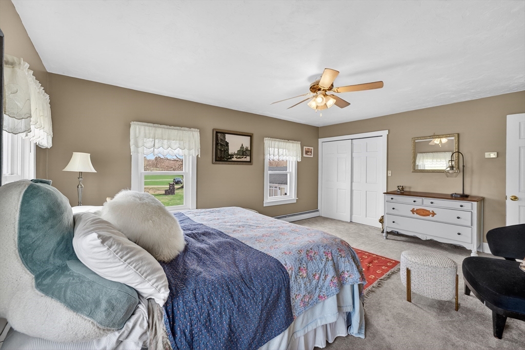 47 Singletary Avenue Sutton, MA 01590 - Photo 28 of 42 a bedroom with a bed and dresser with mirror
