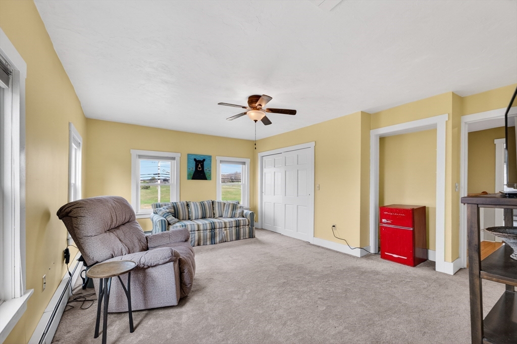 47 Singletary Avenue Sutton, MA 01590 - Photo 30 of 42 a living room with furniture and a ceiling fan