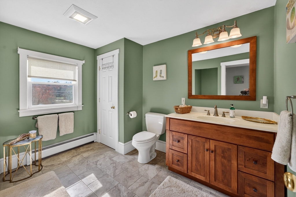 47 Singletary Avenue Sutton, MA 01590 - Photo 31 of 42 a spacious bathroom with a toilet sink and mirror
