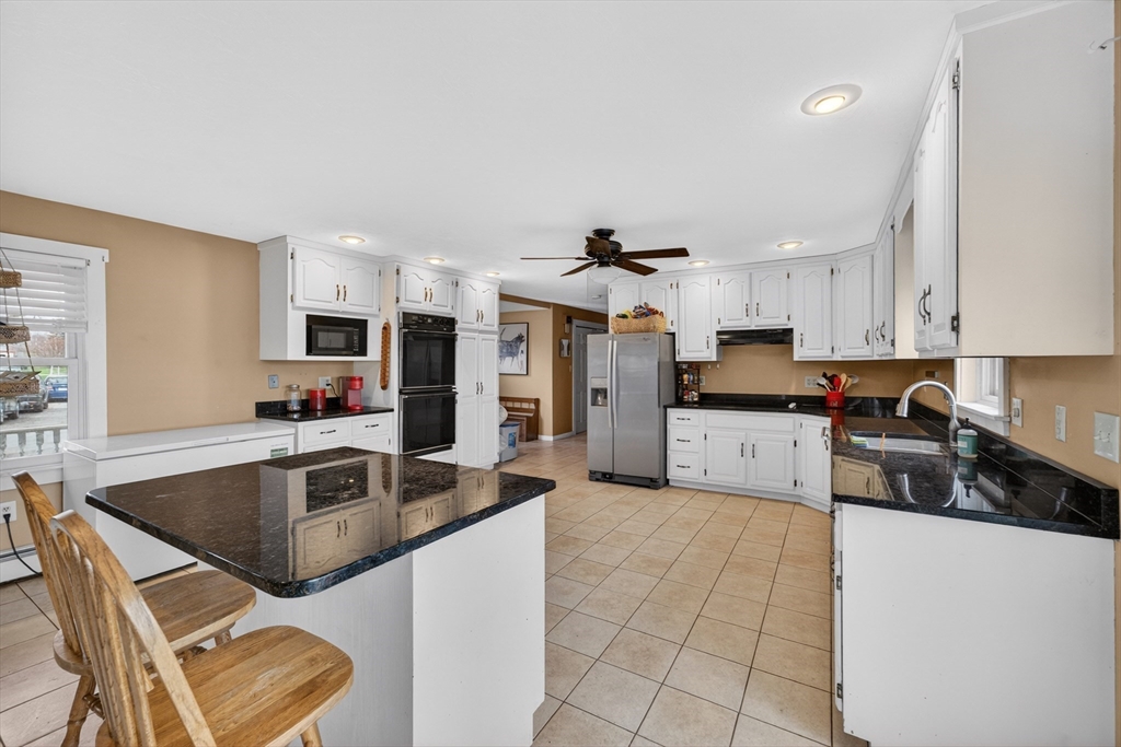 47 Singletary Avenue Sutton, MA 01590 - Photo 9 of 42 a kitchen with stainless steel appliances granite countertop a sink and a refrigerator