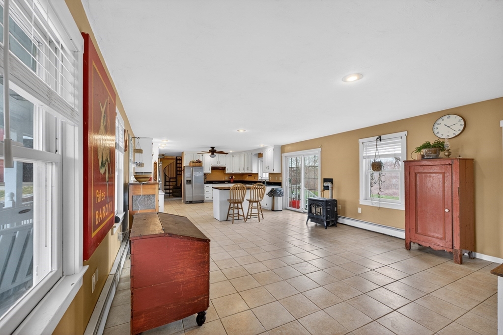 47 Singletary Avenue Sutton, MA 01590 - Photo 10 of 42 a living room with furniture and a refrigerator