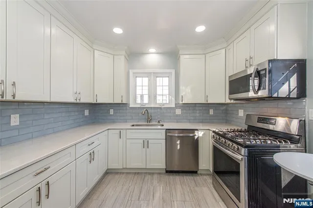 a kitchen with a sink stove and cabinets