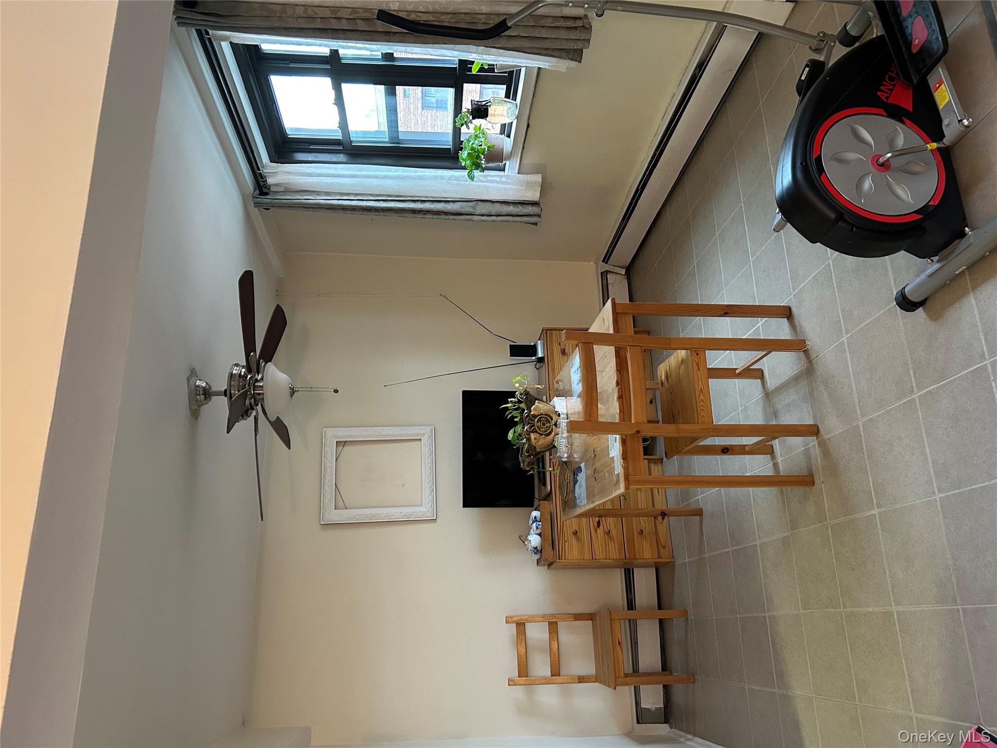 99-05 59th Avenue, Unit 6B Queens, NY 11368 - Photo 7 of 16 Office with a baseboard radiator, ceiling fan, and light tile patterned flooring