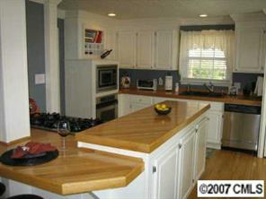 4322 Applegate Road Charlotte, NC 28209 - Photo 2 of 8 a kitchen with a sink a stove and cabinets