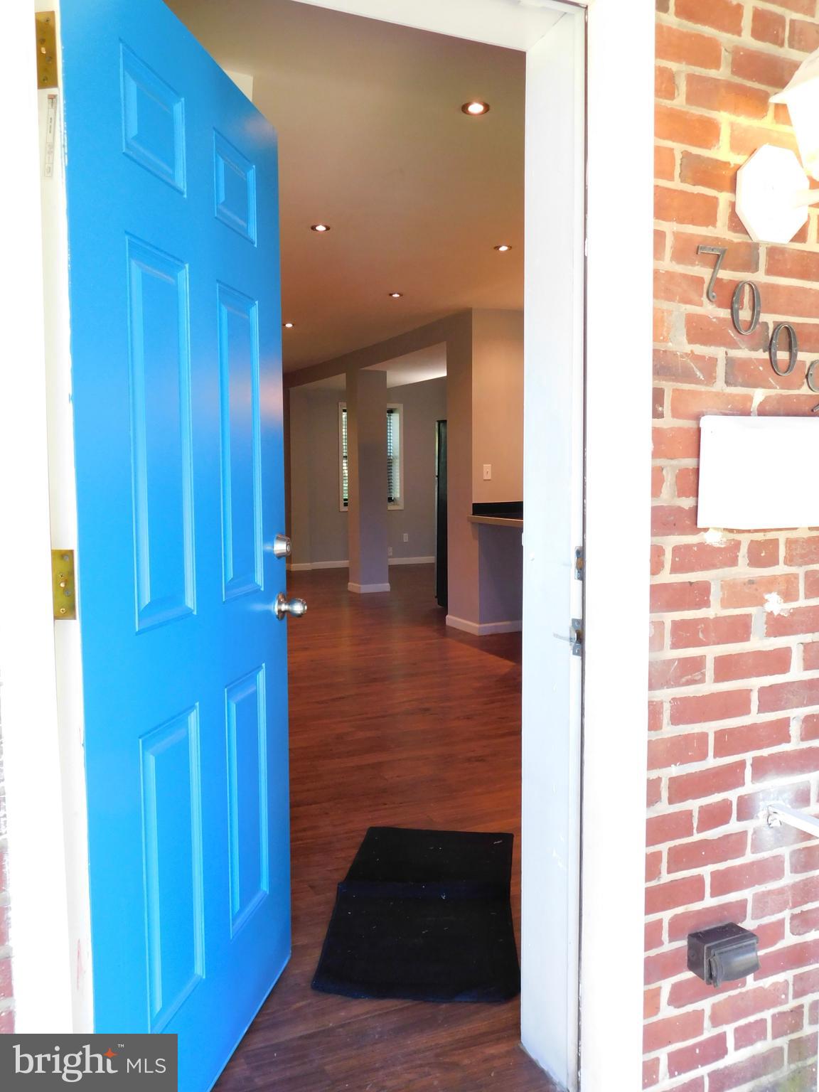 7009 Fieldcrest Road Baltimore, MD 21215 - Photo 3 of 46 a view of a hallway with wooden floor and staircase