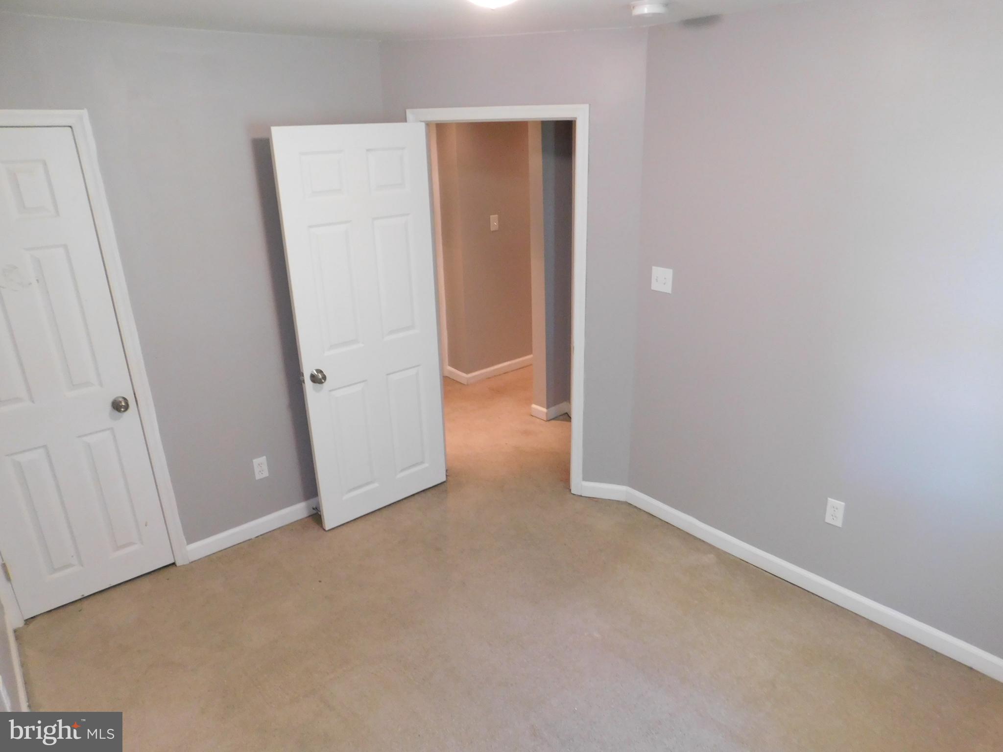 7009 Fieldcrest Road Baltimore, MD 21215 - Photo 24 of 46 an empty room with closet and mirror