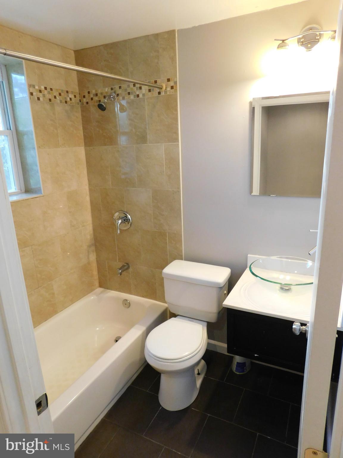 7009 Fieldcrest Road Baltimore, MD 21215 - Photo 26 of 46 a bathroom with a toilet a sink and bathtub