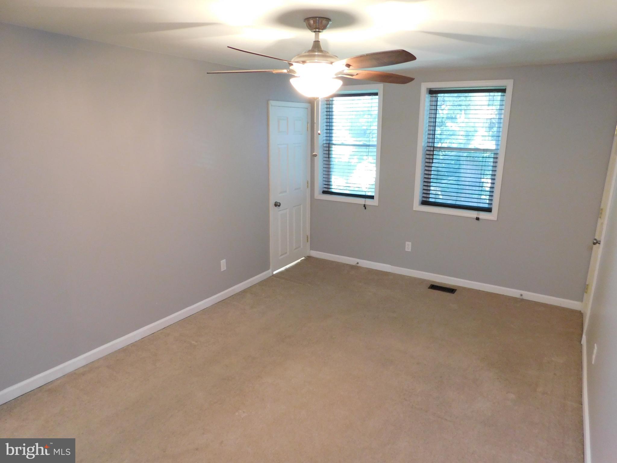 7009 Fieldcrest Road Baltimore, MD 21215 - Photo 29 of 46 an empty room with a window and a fan