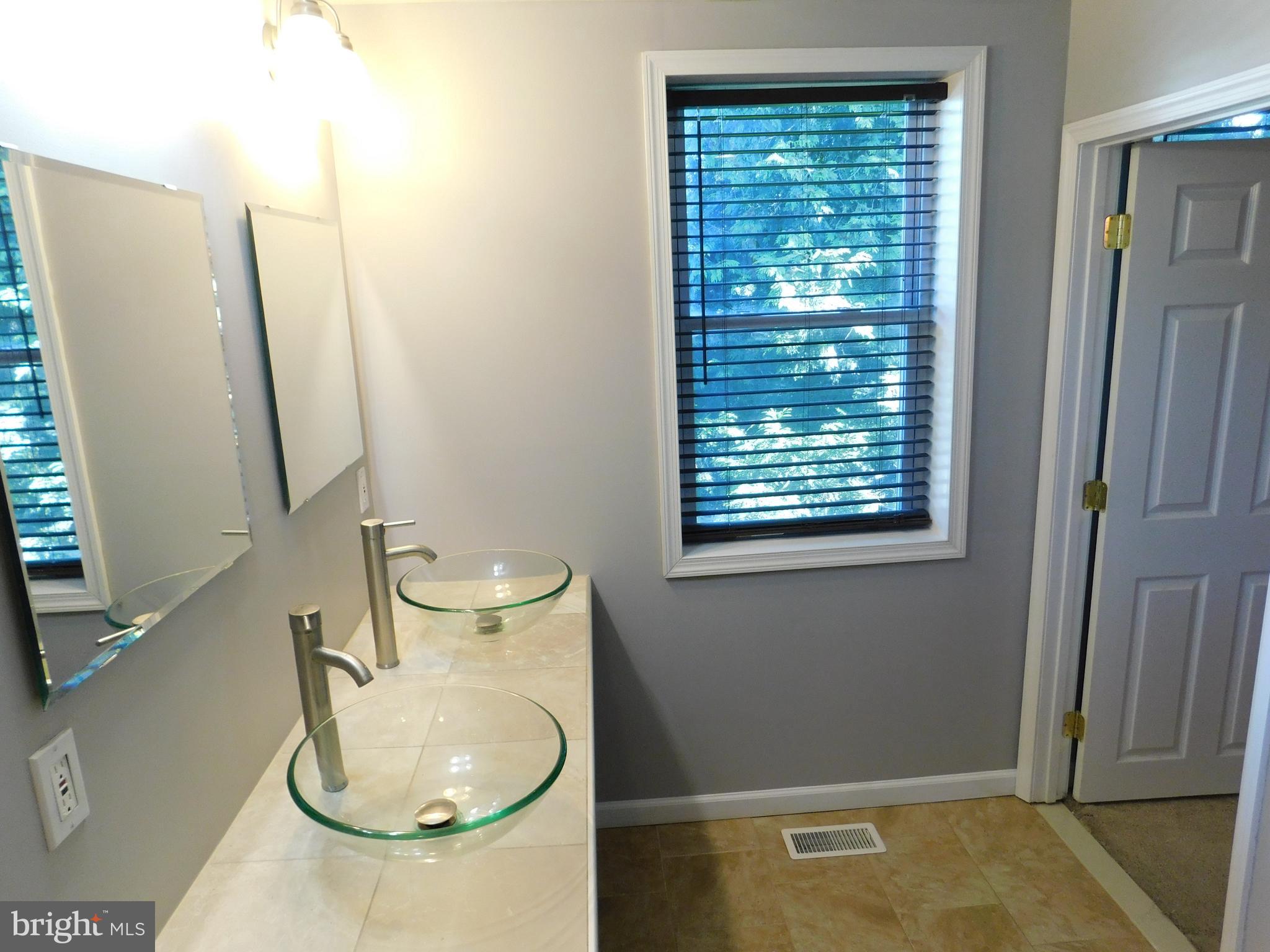 7009 Fieldcrest Road Baltimore, MD 21215 - Photo 33 of 46 a bathroom with a sink toilet and a mirror