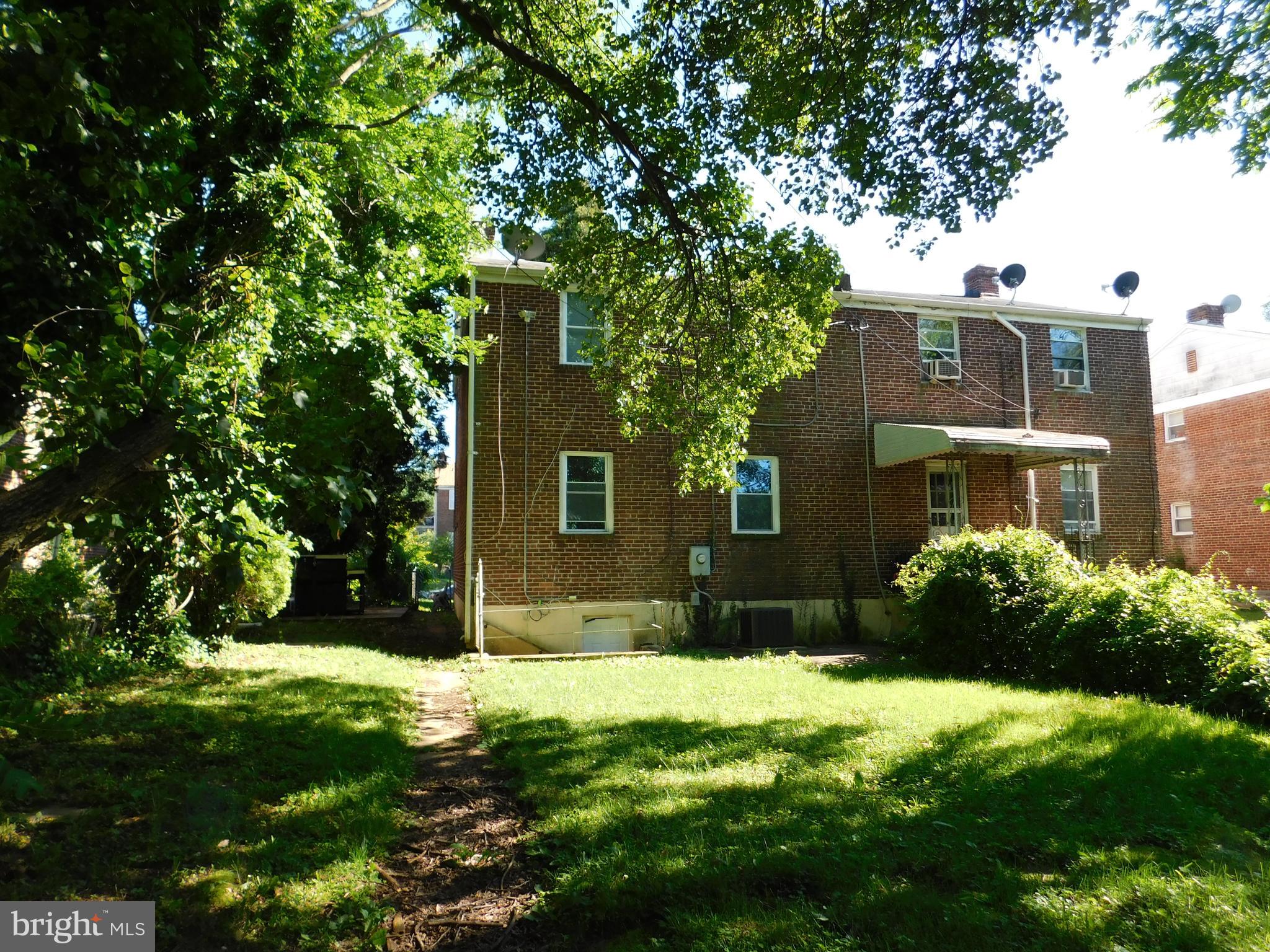 7009 Fieldcrest Road Baltimore, MD 21215 - Photo 34 of 46 a view of a brick house with a yard