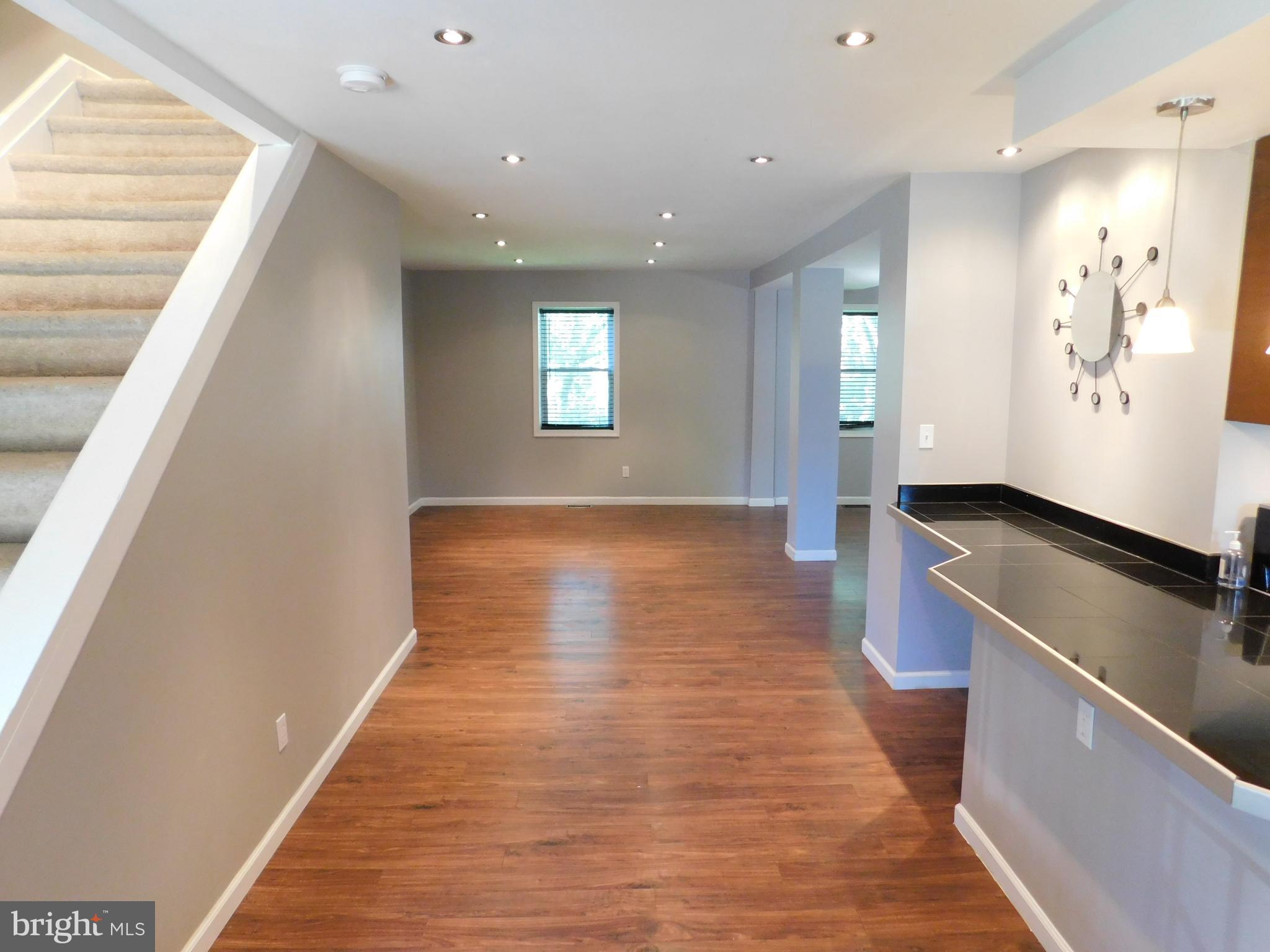 7009 Fieldcrest Road Baltimore, MD 21215 - Photo 45 of 46 a view of a hallway with wooden floor and staircase