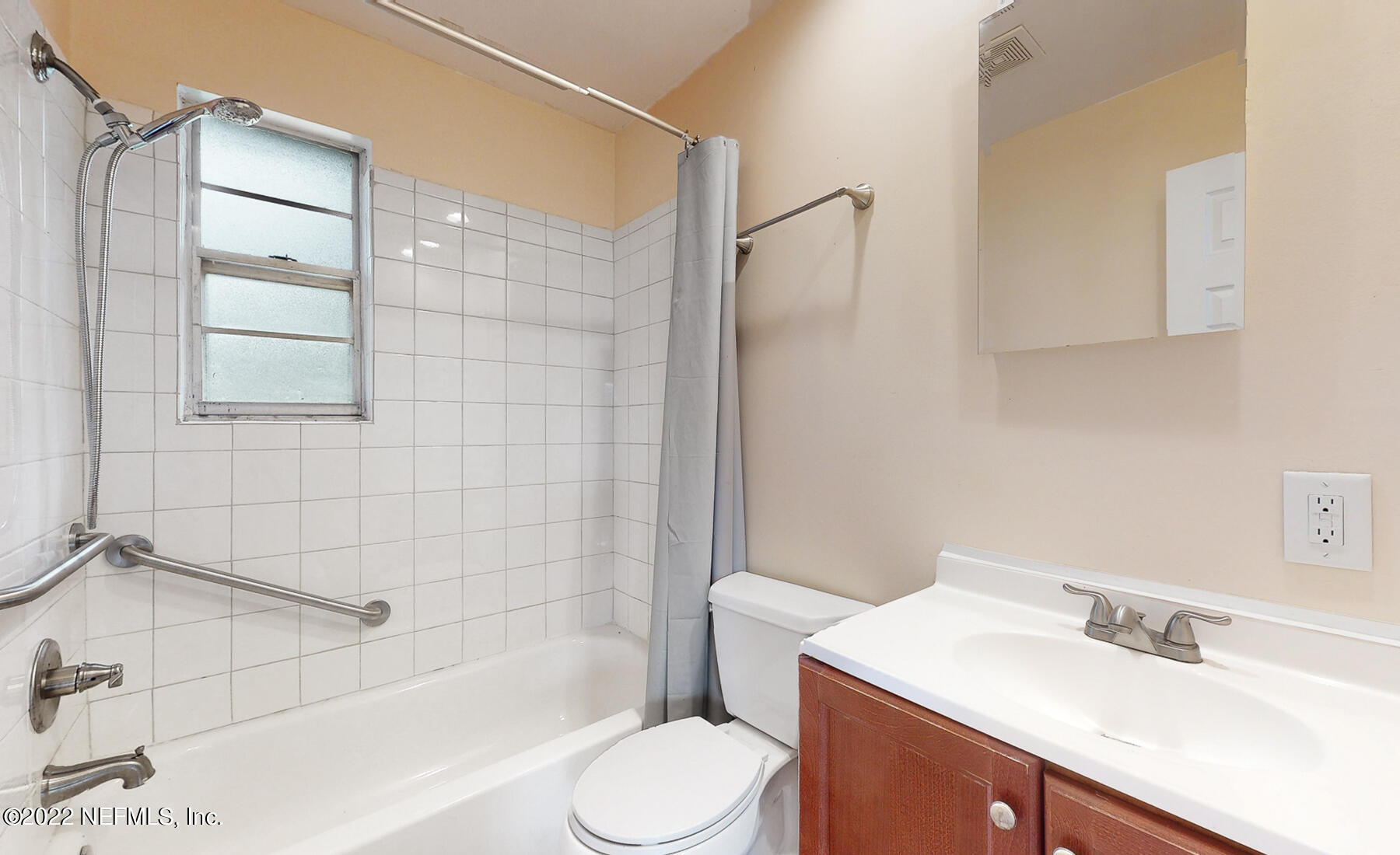 7403 Proxima Road Jacksonville, FL 32210 - Photo 11 of 30 a bathroom with a sink toilet vanity and shower