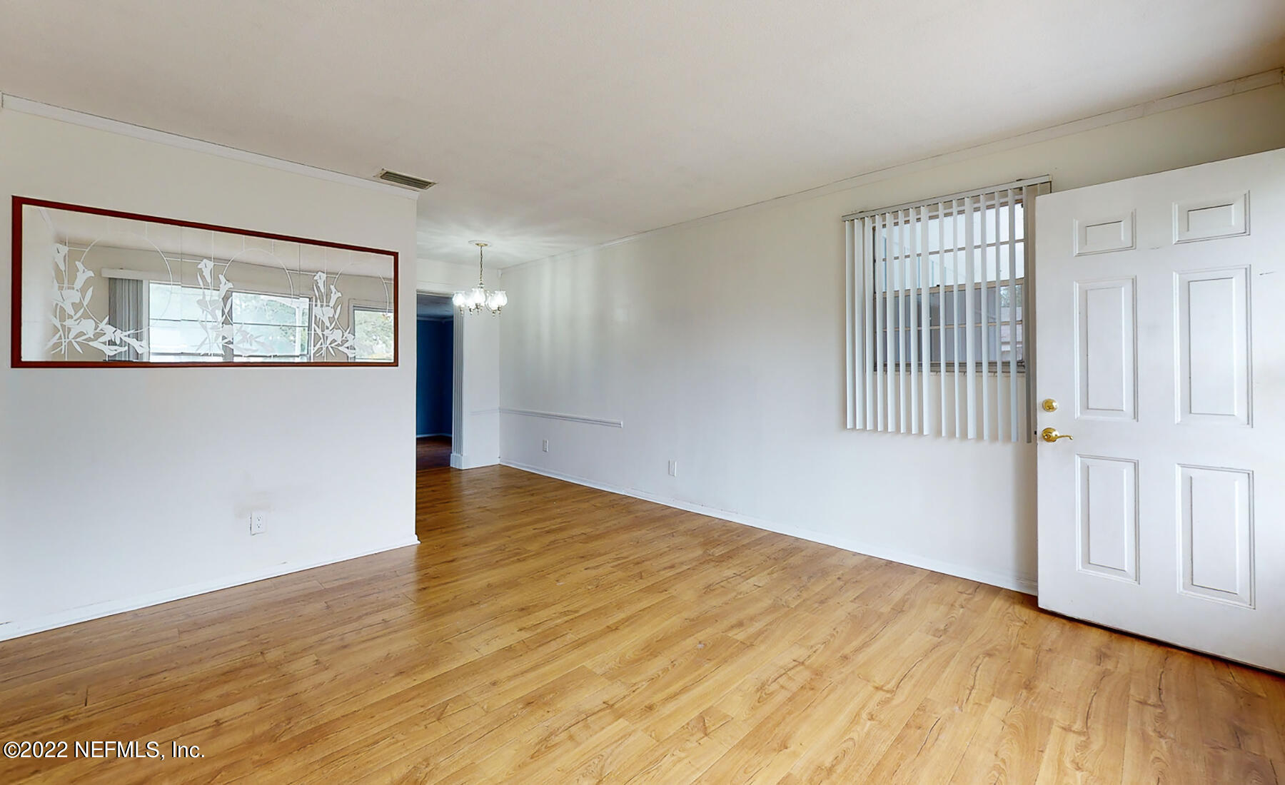 7403 Proxima Road Jacksonville, FL 32210 - Photo 17 of 30 a view of an empty room with wooden floor and a window