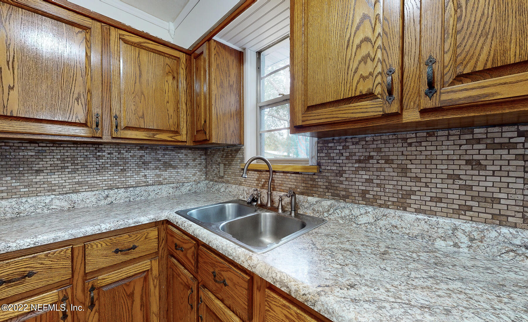 7403 Proxima Road Jacksonville, FL 32210 - Photo 19 of 30 a kitchen with stainless steel appliances granite countertop a sink a stove and cabinets