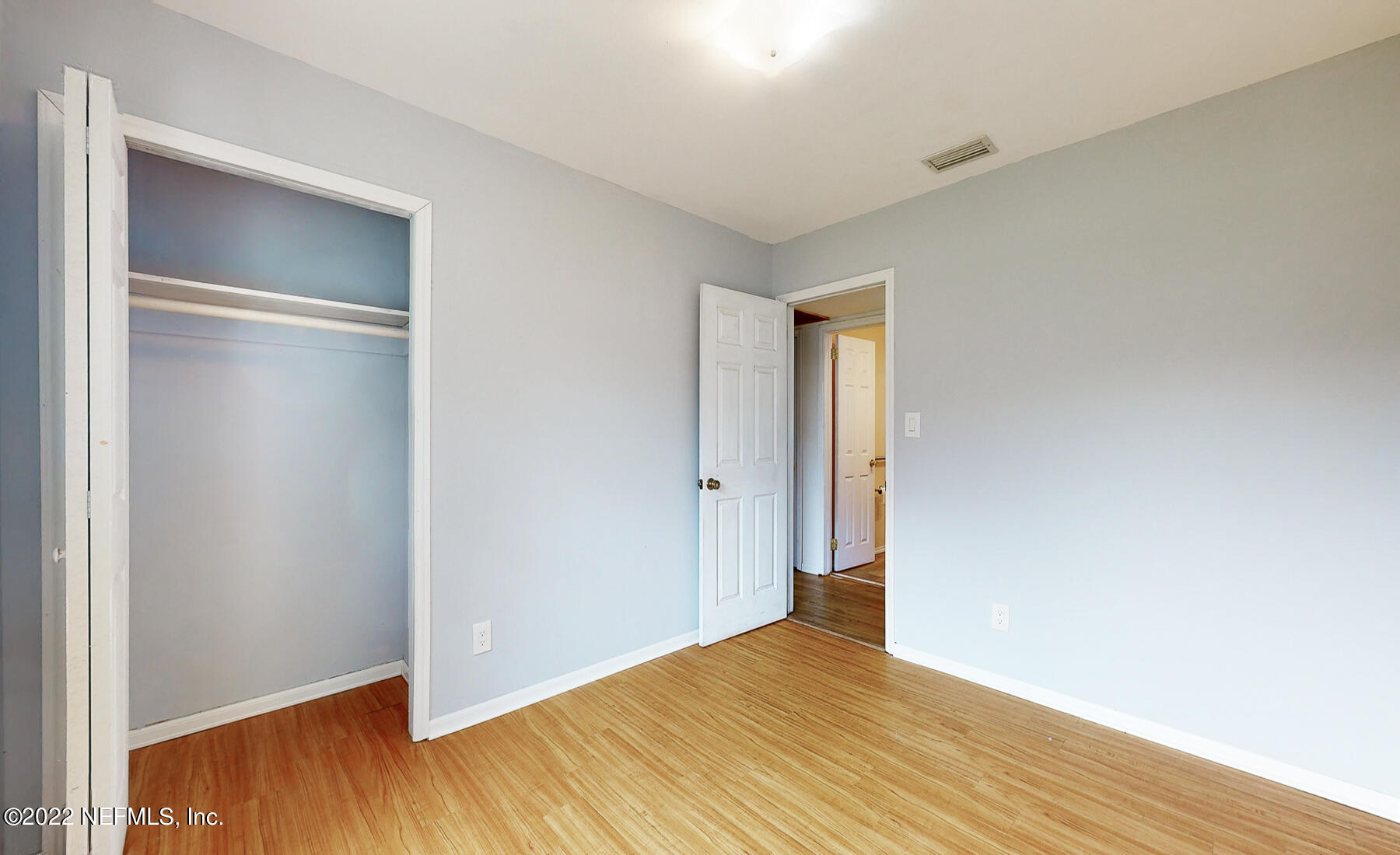 7403 Proxima Road Jacksonville, FL 32210 - Photo 20 of 30 a view of an empty room with wooden floor
