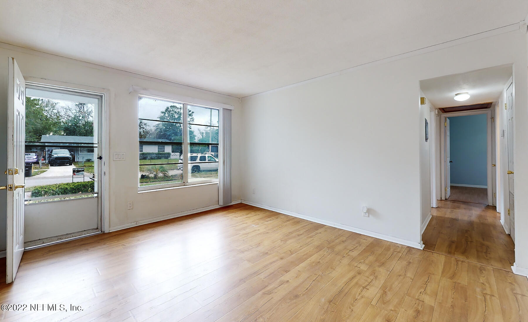 7403 Proxima Road Jacksonville, FL 32210 - Photo 3 of 30 a view of an empty room with a window and wooden floor