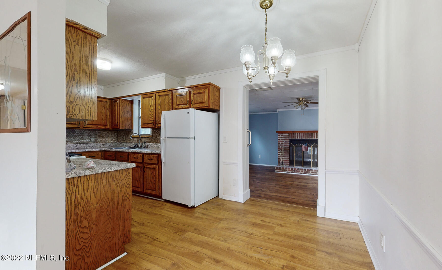 7403 Proxima Road Jacksonville, FL 32210 - Photo 4 of 30 a view of a kitchen with a sink refrigerator and wooden floor