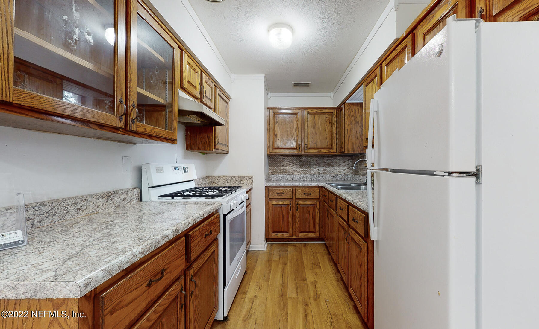 7403 Proxima Road Jacksonville, FL 32210 - Photo 5 of 30 a kitchen with stainless steel appliances granite countertop a stove a sink and a refrigerator
