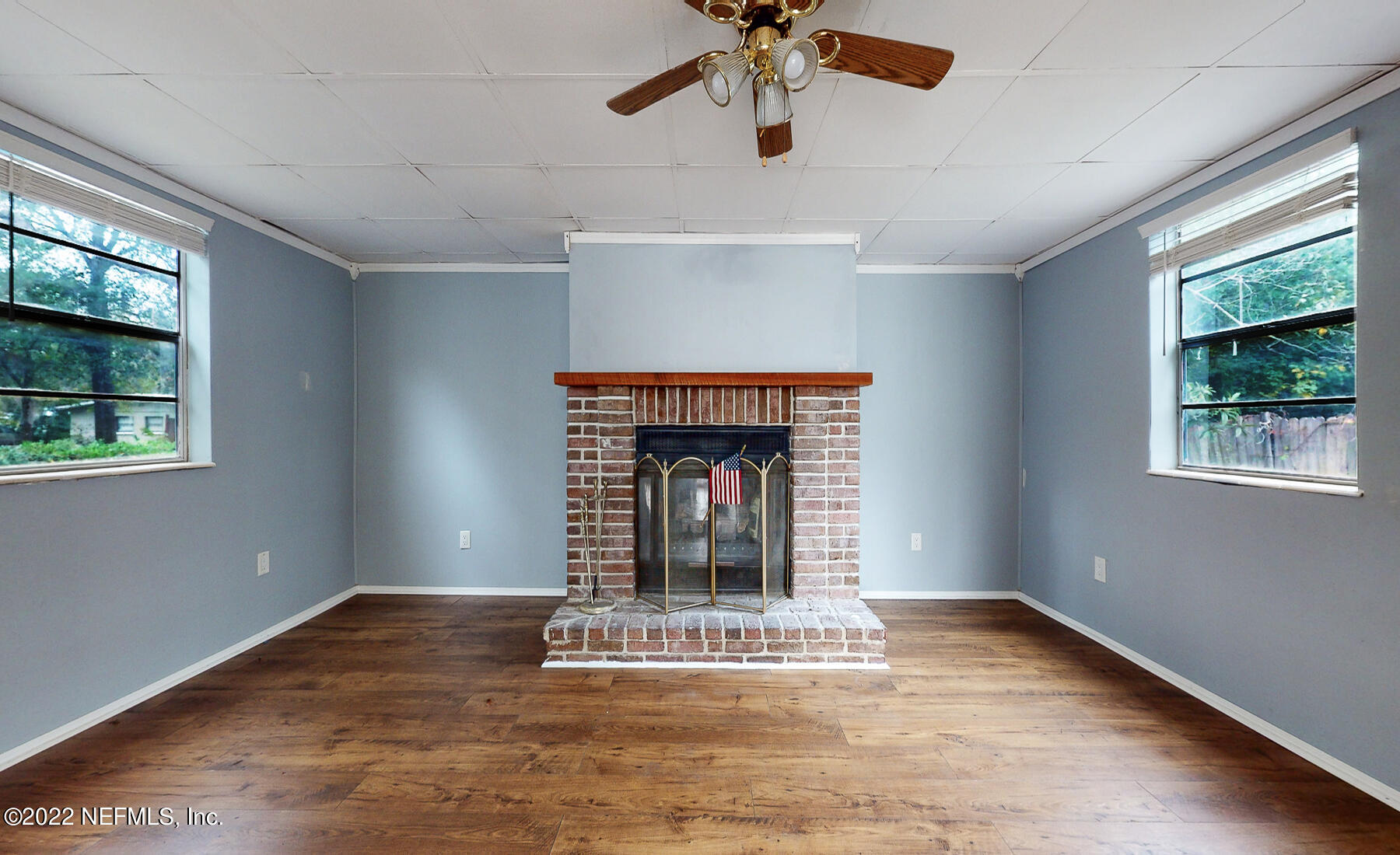 7403 Proxima Road Jacksonville, FL 32210 - Photo 6 of 30 a view of an empty room with a window and fireplace