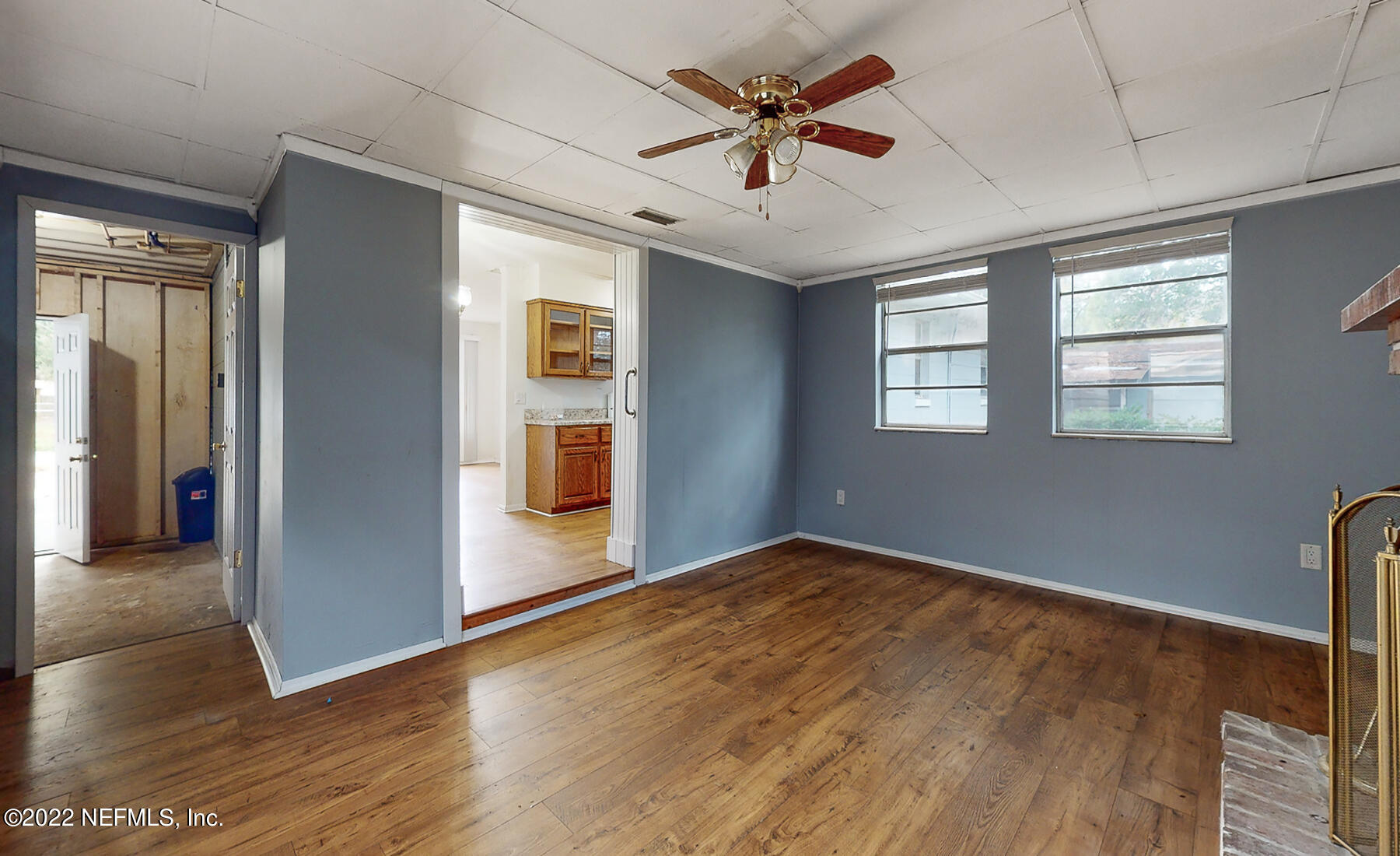7403 Proxima Road Jacksonville, FL 32210 - Photo 7 of 30 a view of an empty room with window and wooden floor