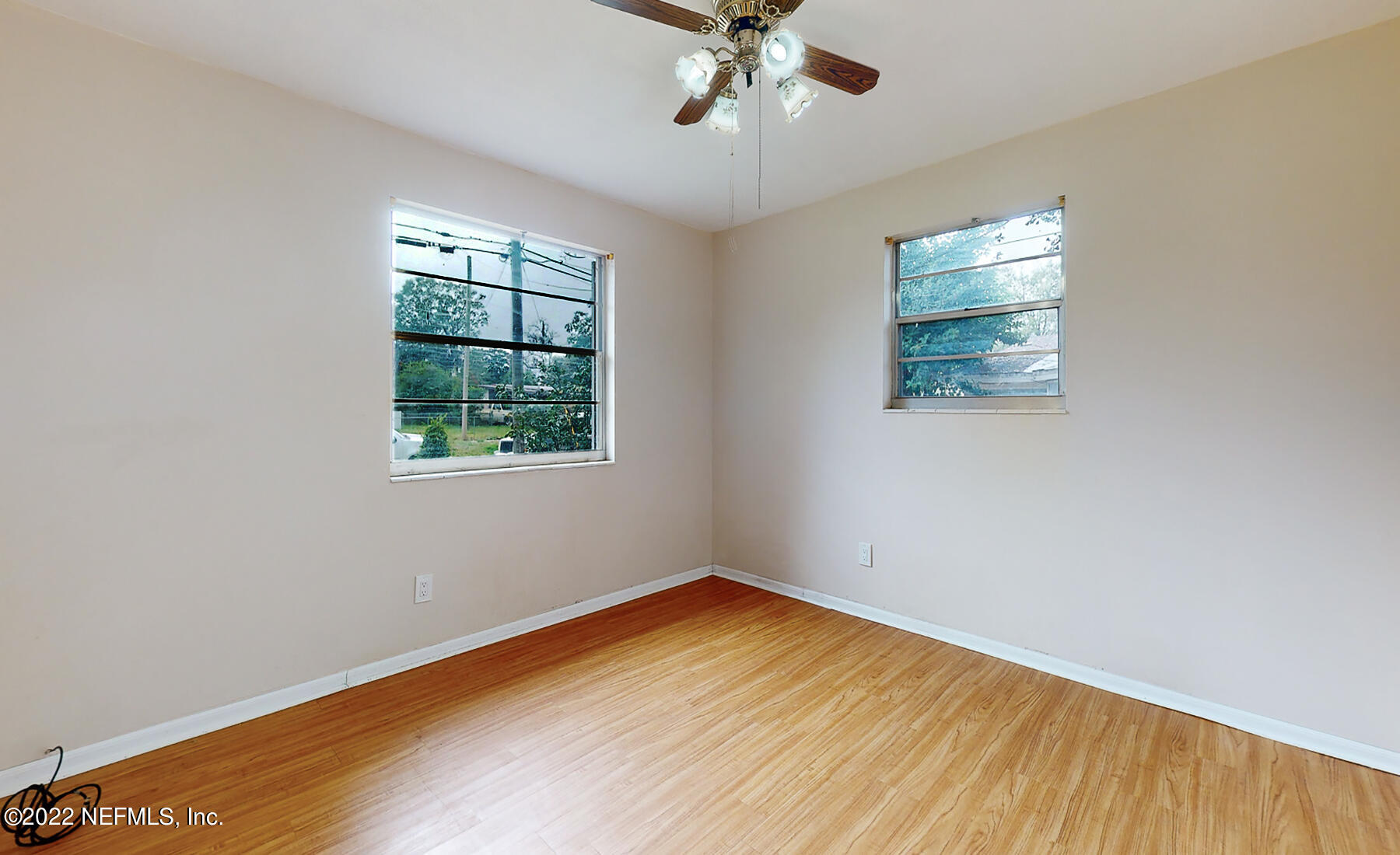 7403 Proxima Road Jacksonville, FL 32210 - Photo 9 of 30 wooden floor in an empty room with a window