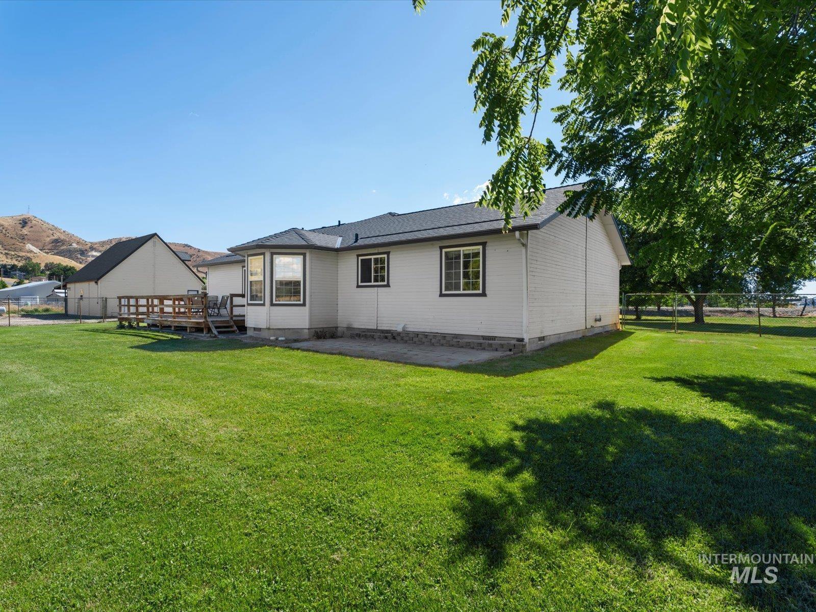 3540 Wills Road Emmett, ID 83617 - Photo 32 of 36 Expansive green lawn surrounds the property, featuring a multi-level wooden deck and a bay window
