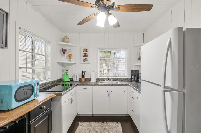 a kitchen with stainless steel appliances a sink stove and refrigerator